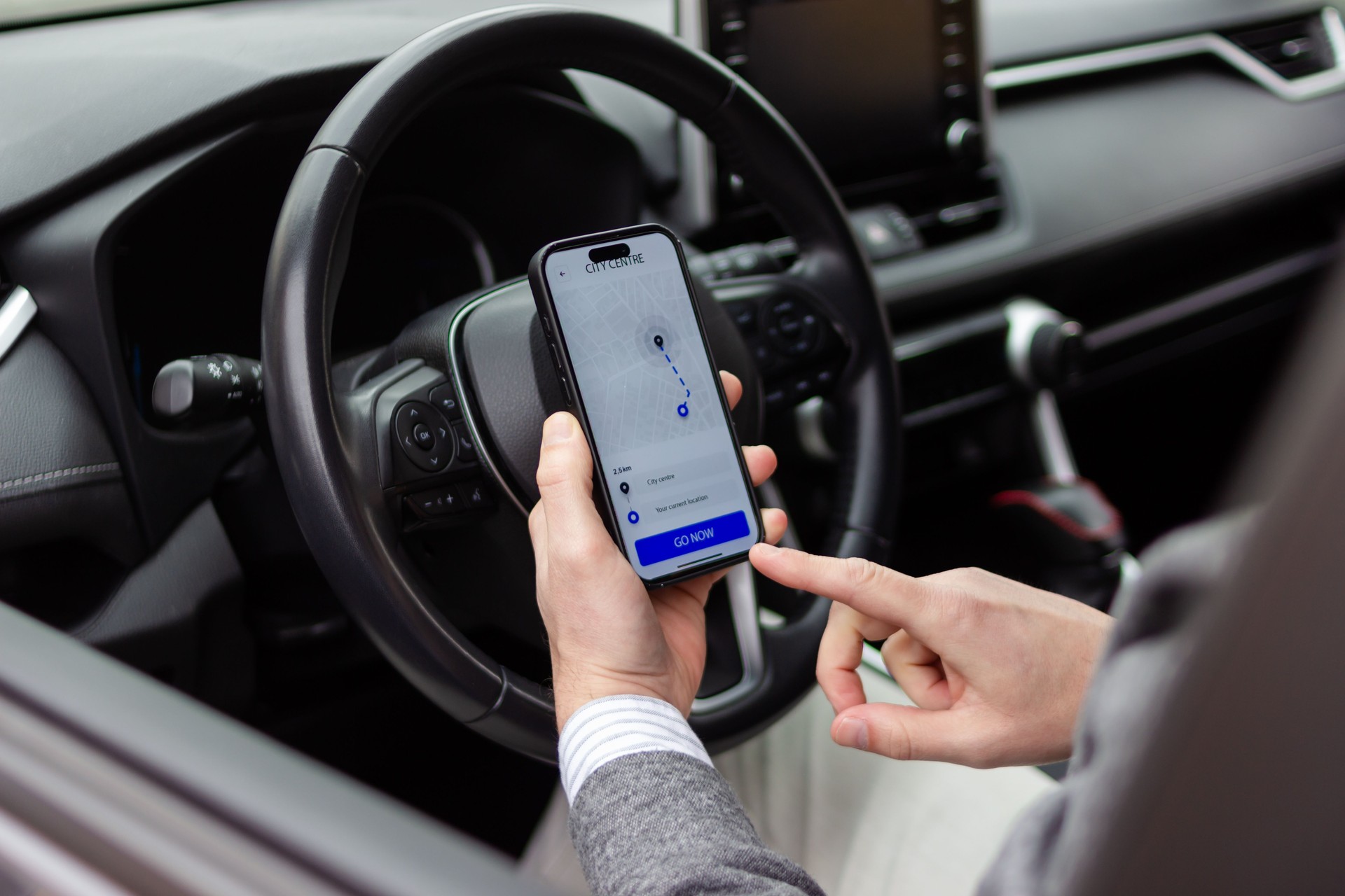 Businessman using gps navigation app on smartphone in car