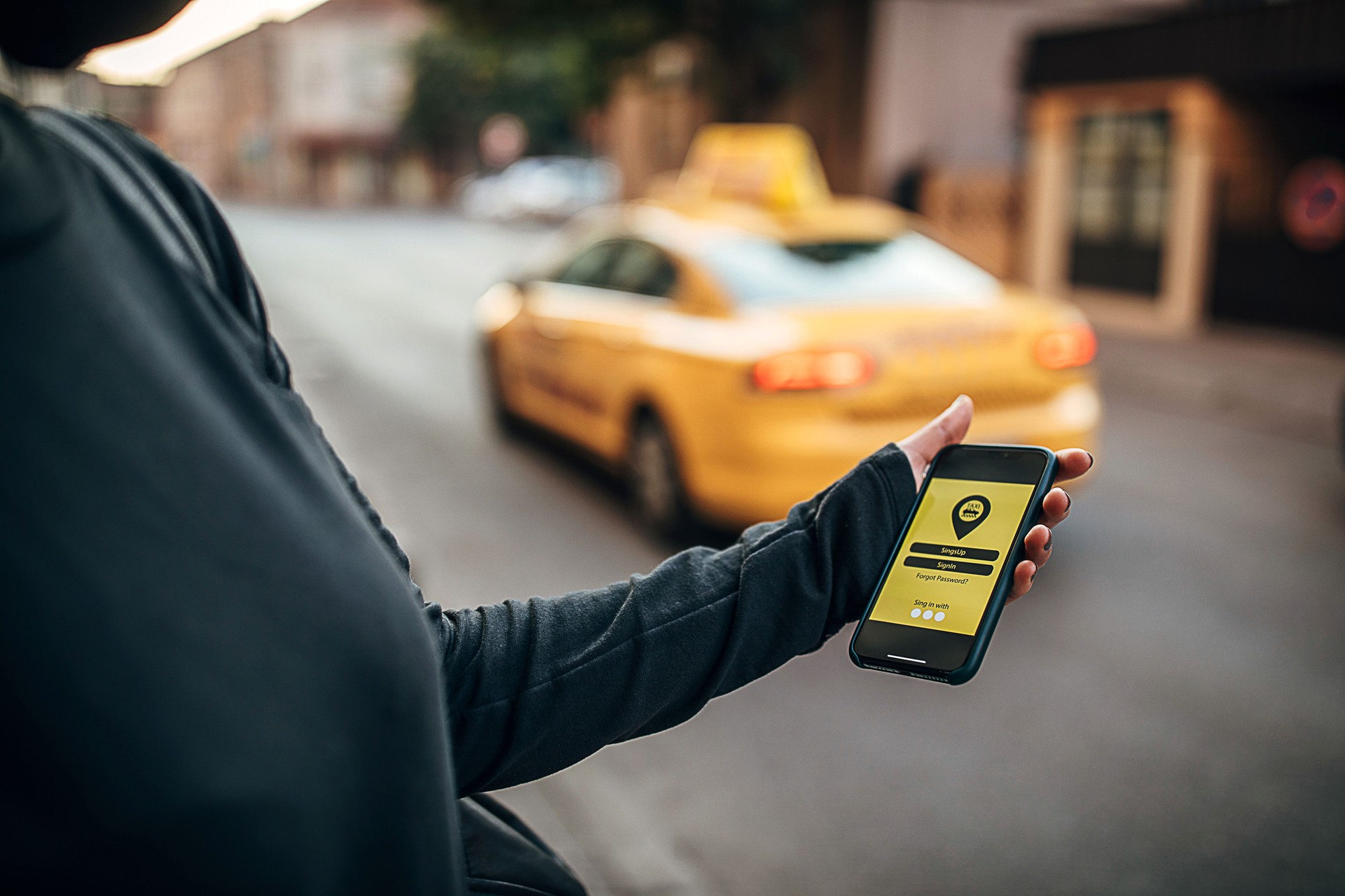 Hand of woman using mobile app on phone on the street